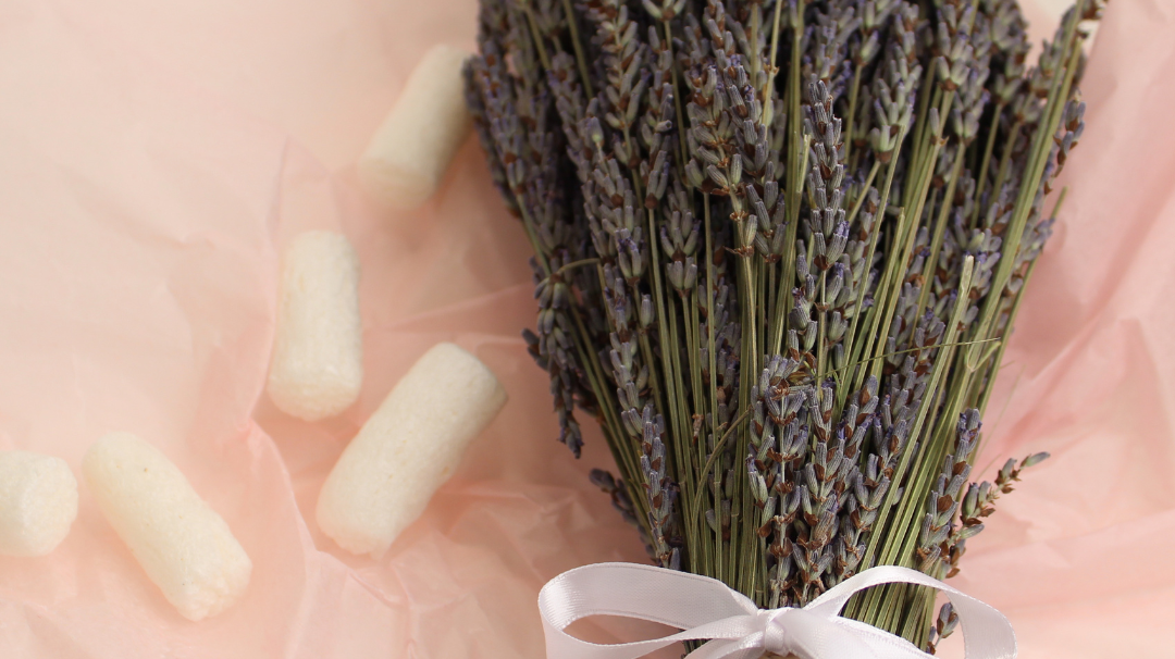 10 Great Gifts Ideas For Someone Who Has Everything featured image showing a dried lavender bouquet tied with a white ribbon, resting on a pink background. The text "Holiday Gift Guide" is superimposed over the image