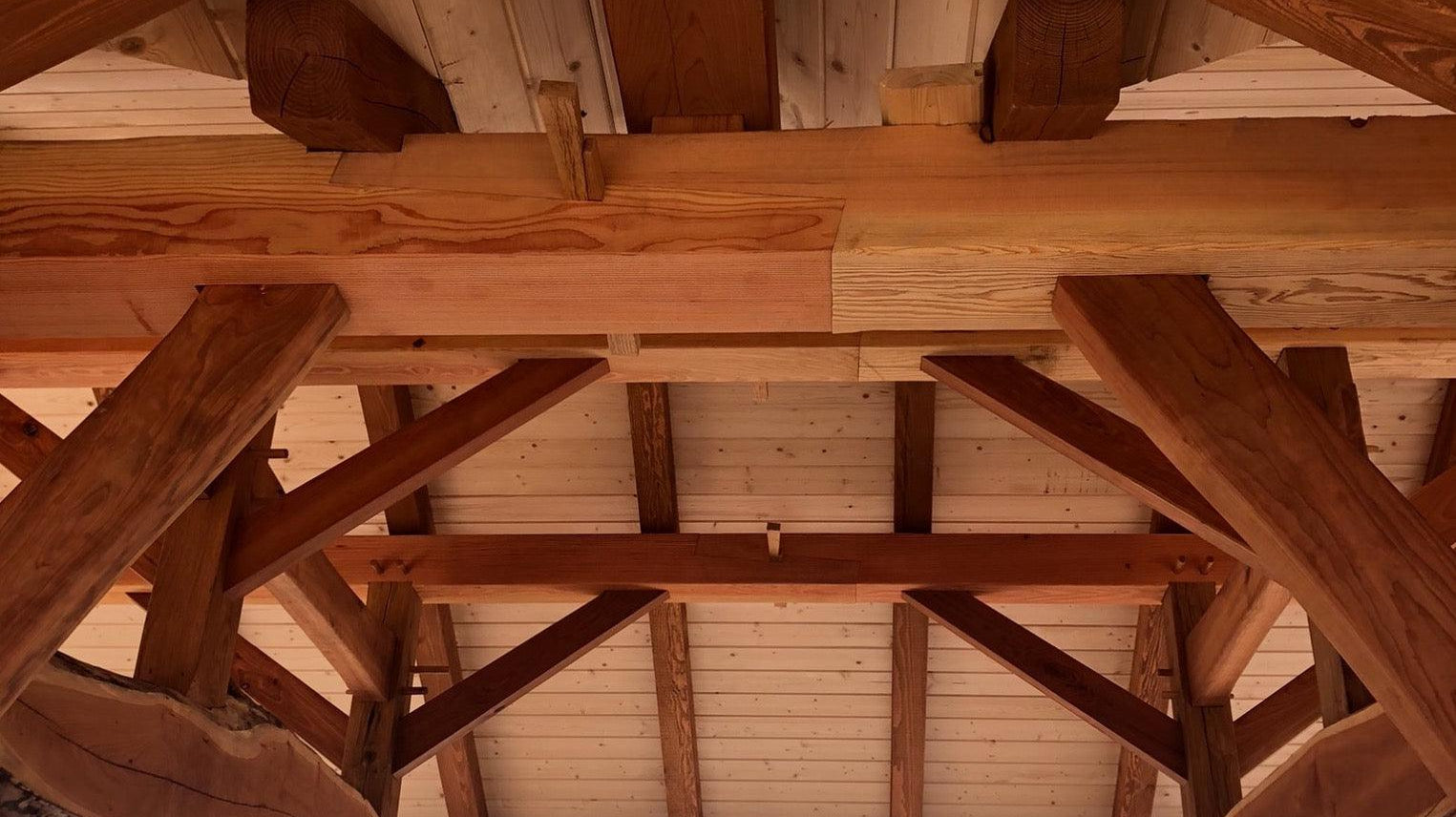 timber frame Pavilions: East Marion and Calverton featured image of a close-up of a timber-framed ceiling, showcasing the intricate joinery and the warm, natural tones of the wood