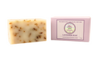 Moisturizing lavender bar soap the best smelling bar soap for woman. The bar soap is light purple with darker speckles and is packaged in a pink box with a white label with the Lavender By The Bay logo