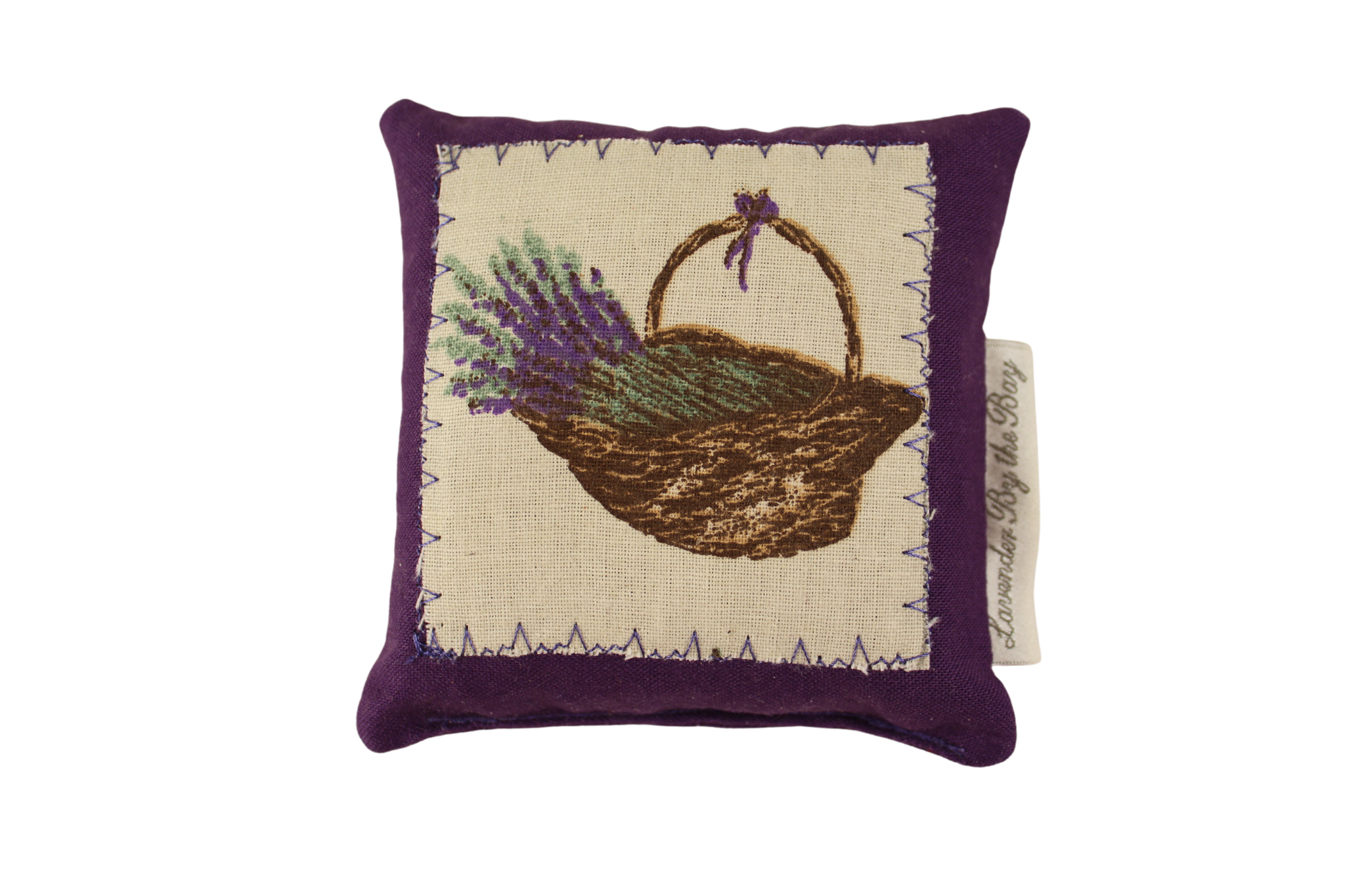 A small, square-shaped lavender filled pillow with an embroidered image of a basket filled with lavender flowers