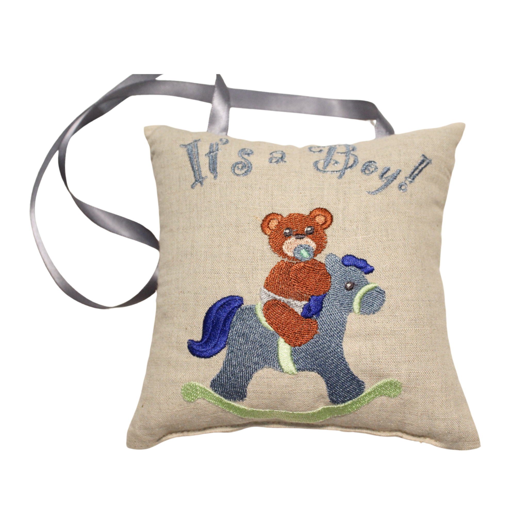 A small, square lavender sachet  with a blue ribbon, embroidered with the text "It's a Boy!" and an image of a teddy bear riding a rocking horse it is a special product as gifts for new parents
