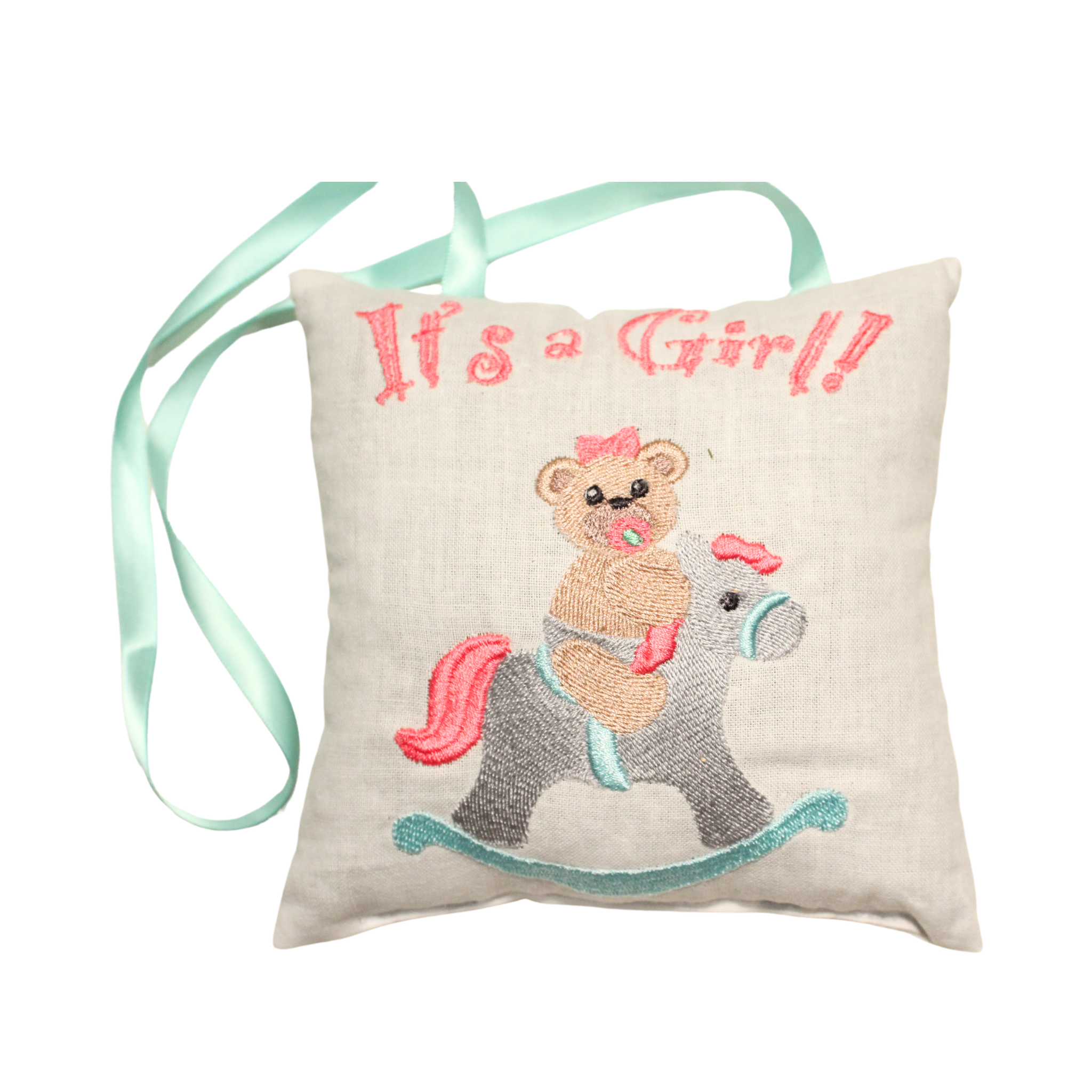 new mom gift A small, square lavender sachet with a pink ribbon, embroidered with the text "It's a Girl!" and an image of a teddy bear riding a rocking horse.