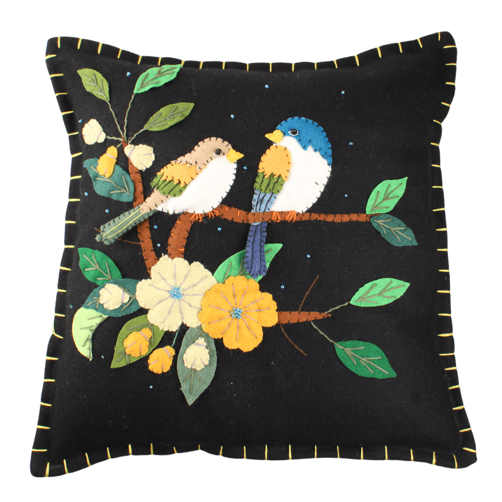 A square felt balck pillow with two embroidered birds perched on a branch with flowers
