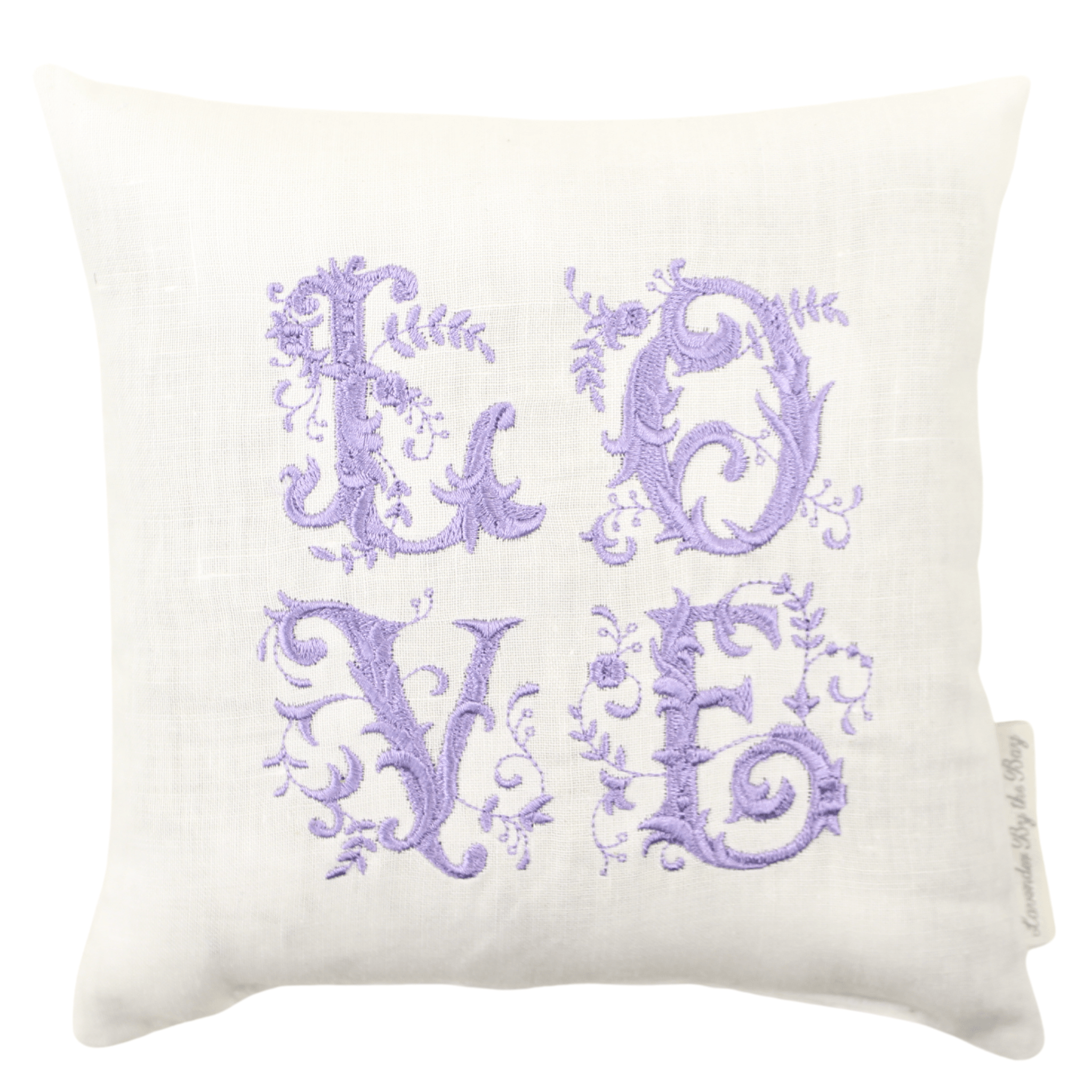 A fragrant home fragrance sachet featuring the word 'LOVE' embroidered in purple on a soft, white pillow.
