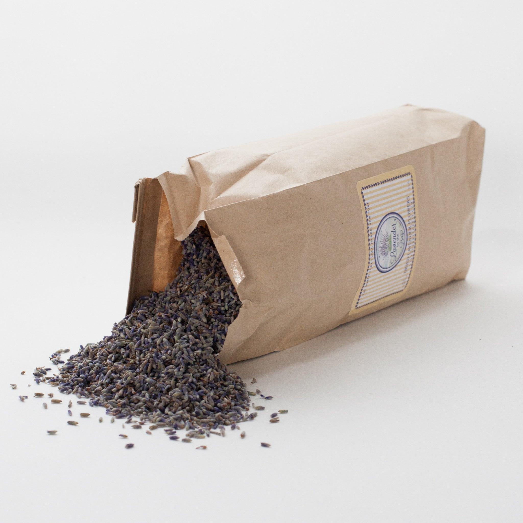 A half-pound of French lavender flowers. The lavender flowers are light purple color and spilled out of a narrow paper bag