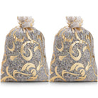 Two decorative gold mesh lavender sachets for moths on white background