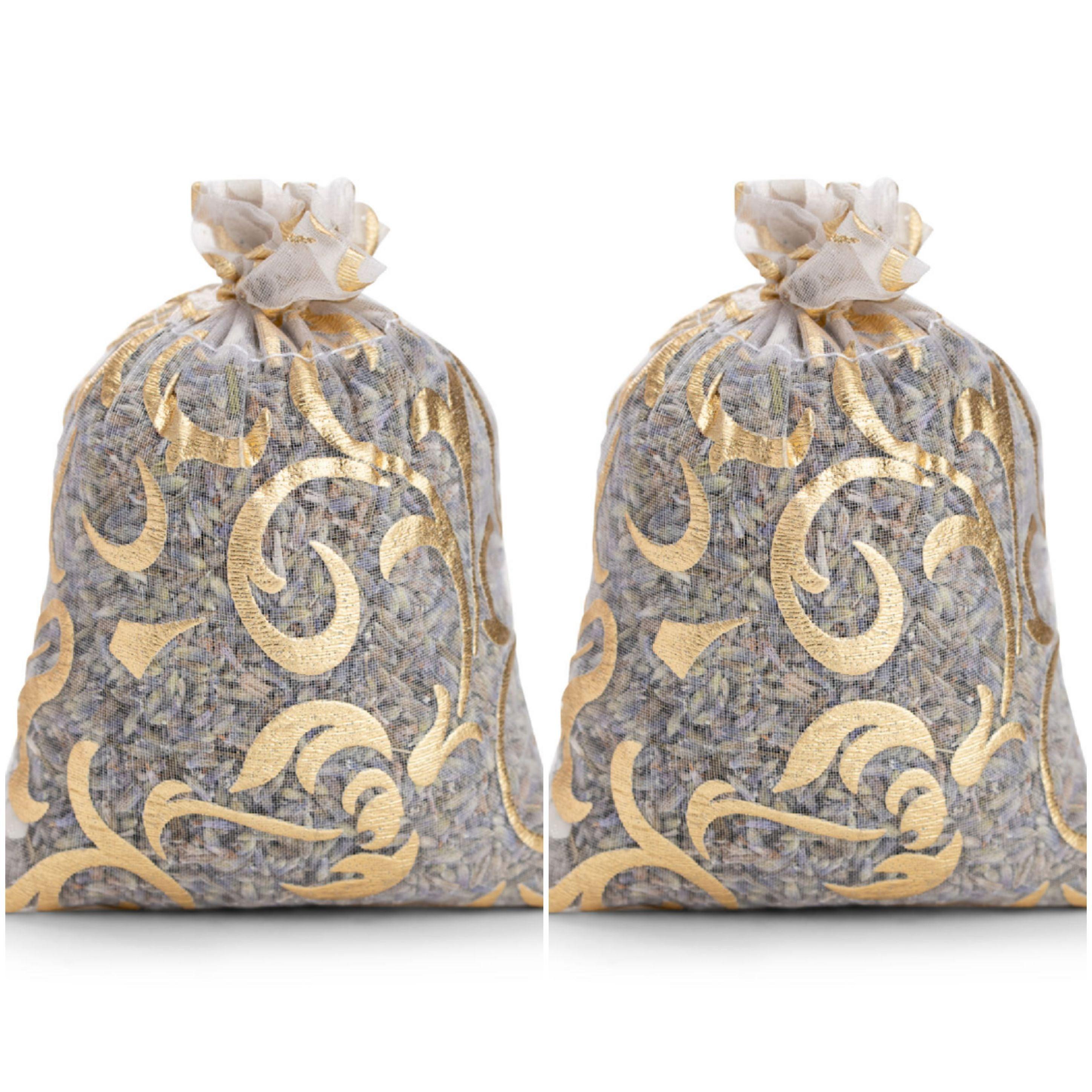 Two decorative gold mesh lavender sachets for moths on white background