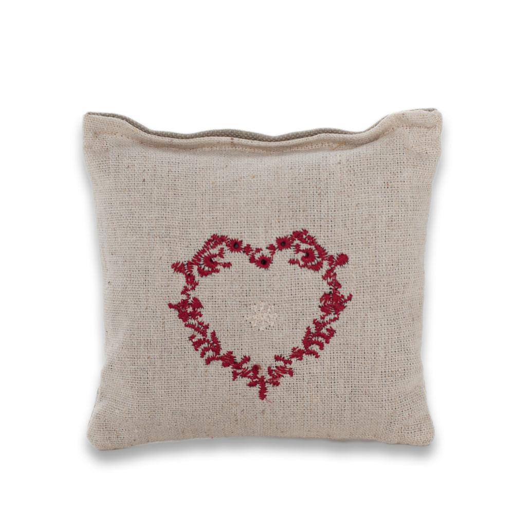 A small, square-shaped lavender filled sachet with an embroidered red heart design.