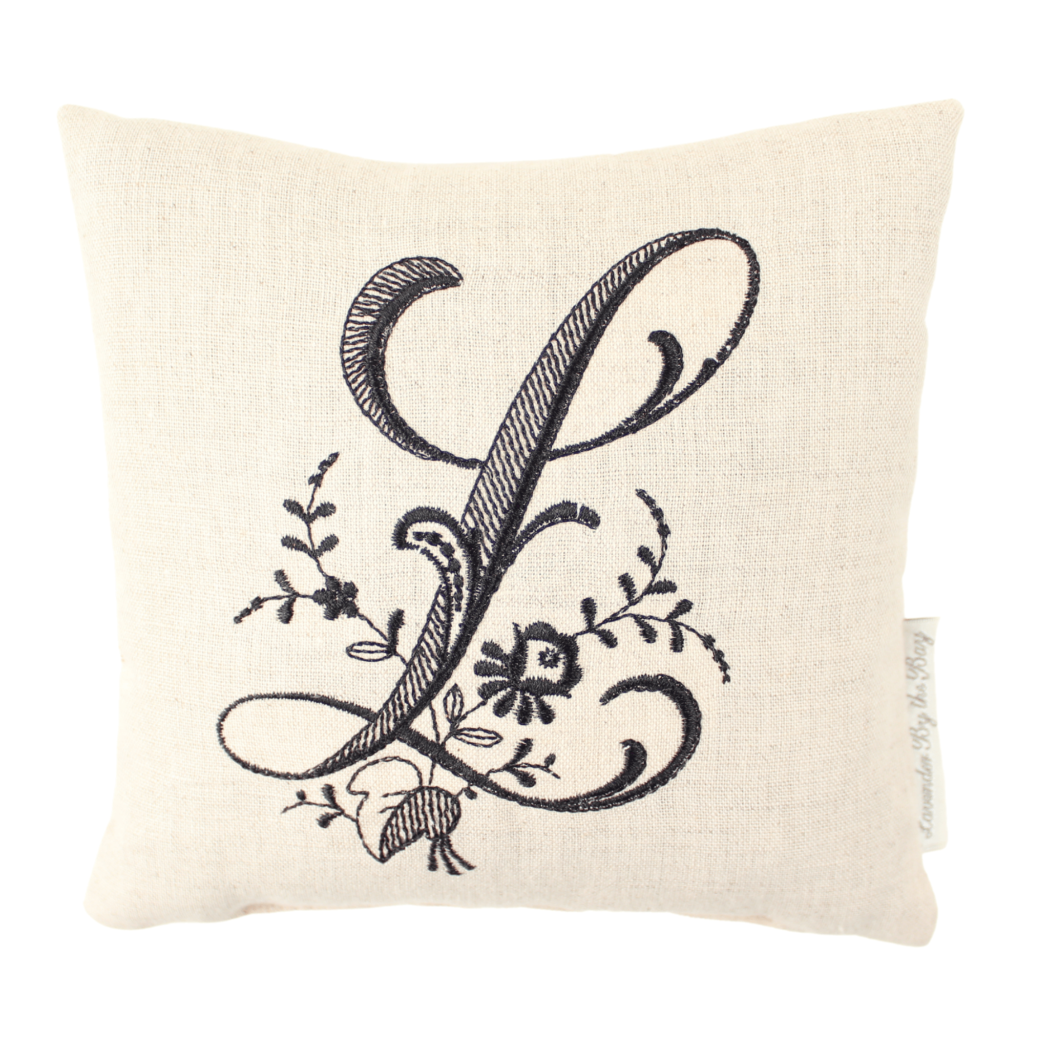 Monogrammed reading pillow for bed with black letter L on white background