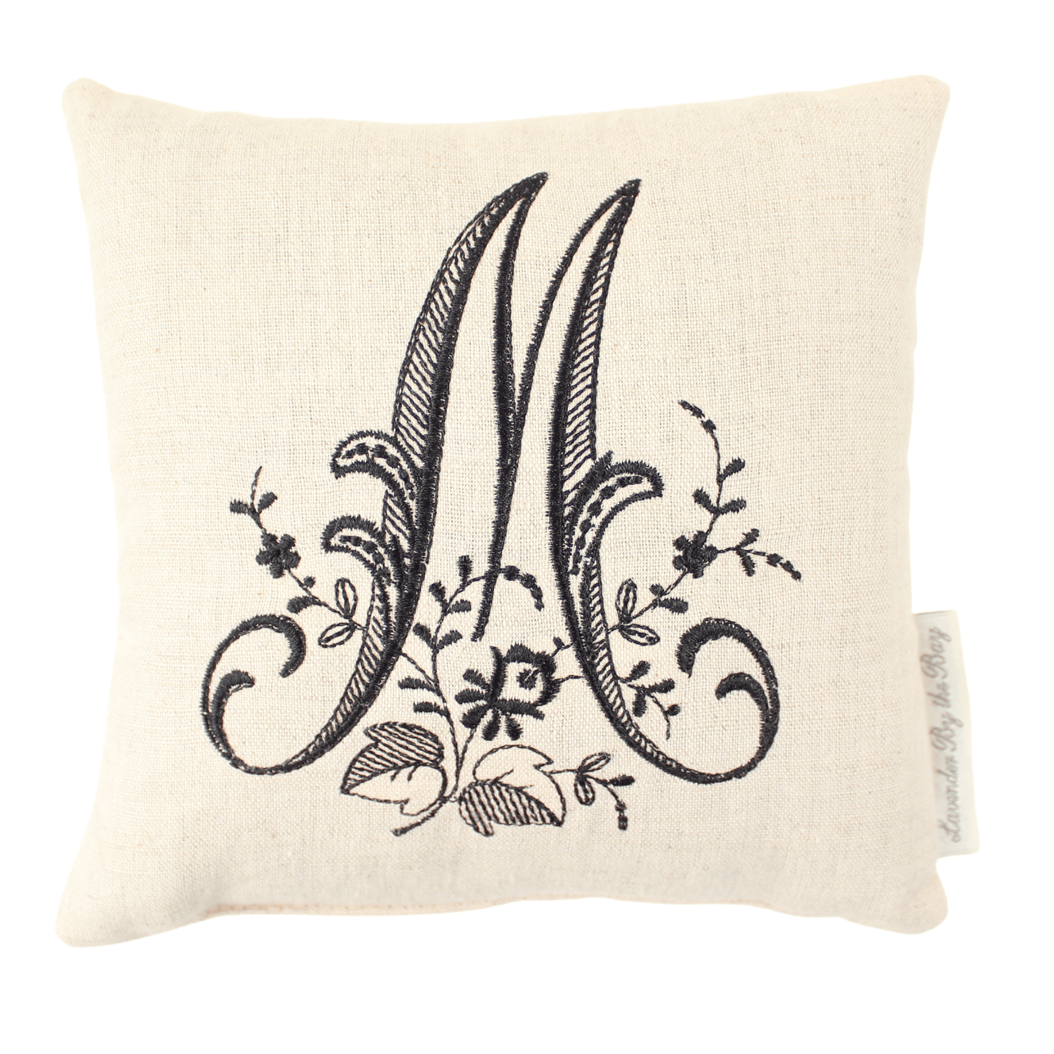 Monogrammed bed reading pillow with black letter M on white background