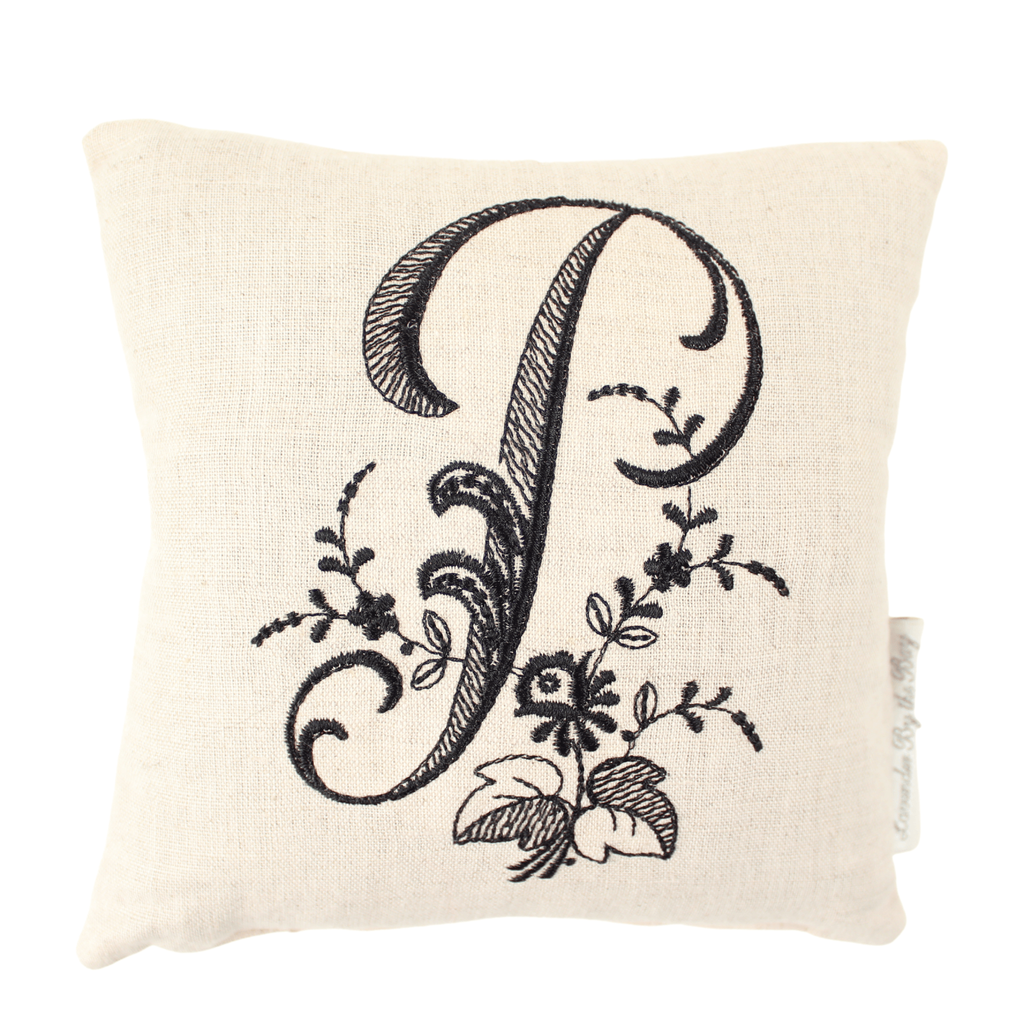 Embroidered monogram pillow with 
black P letter on white background