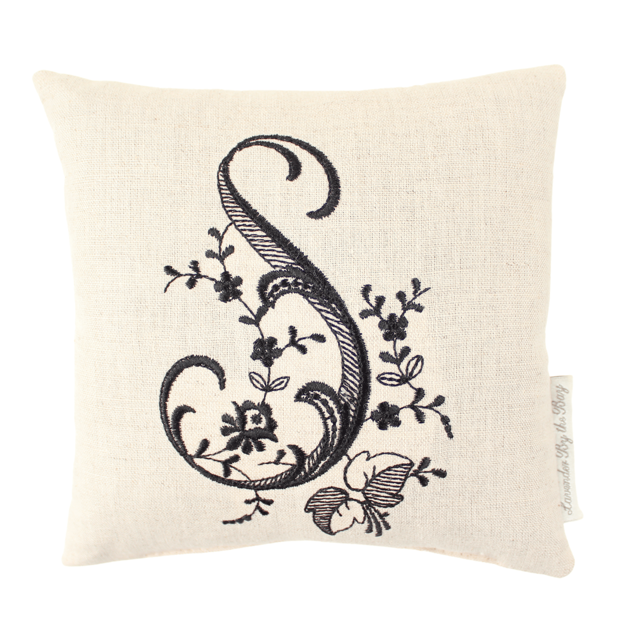 Embroidered monogram pillow with black S letter on white background