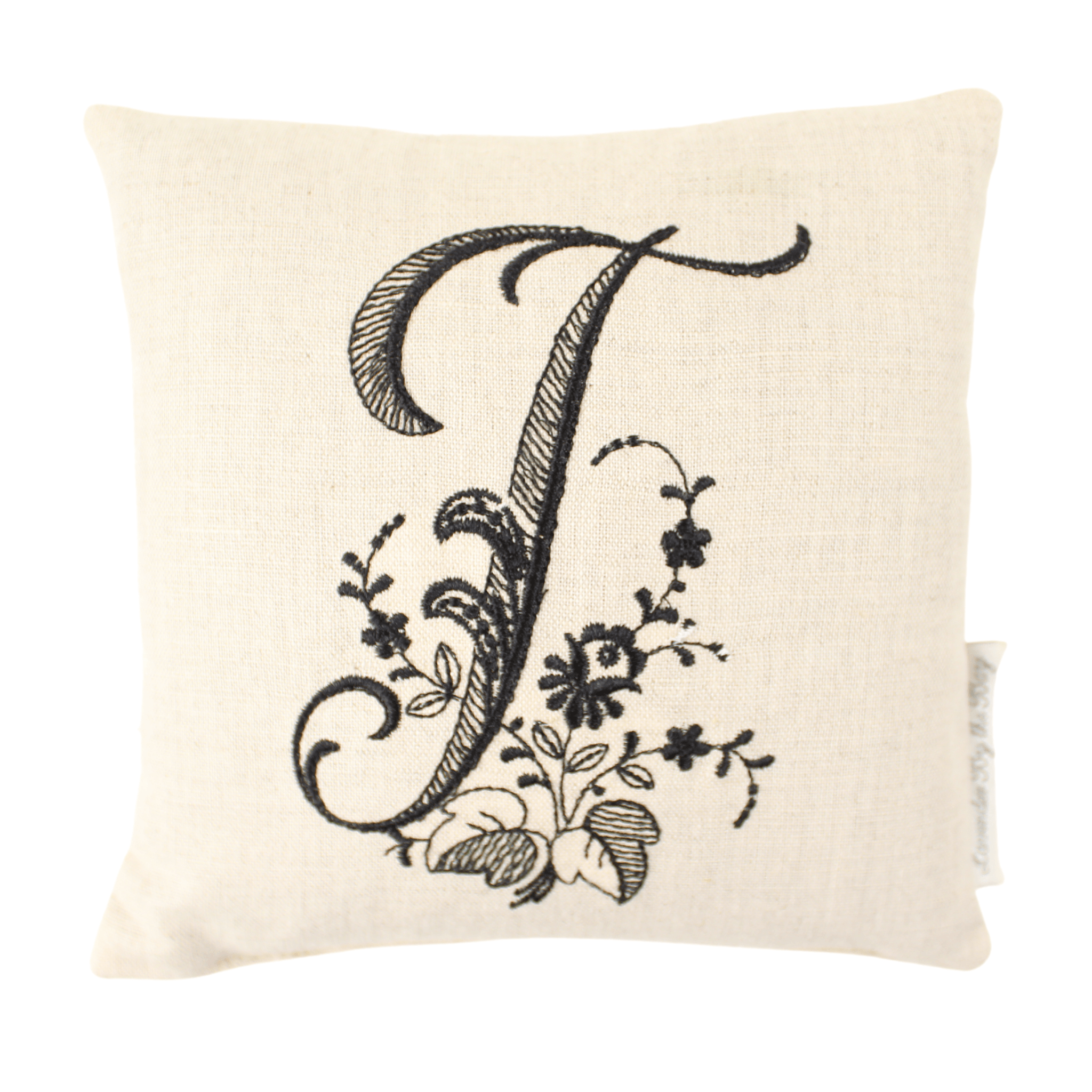 monogrammed cushion with black letter T on white background